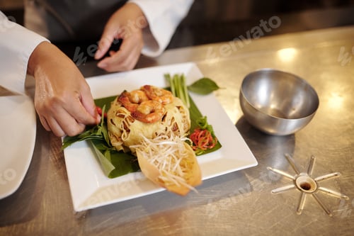 Preview: Cook Garnishing Dish with Greens