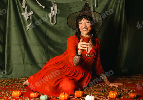Preview: A beautiful young woman in a witch costume at Halloween party.