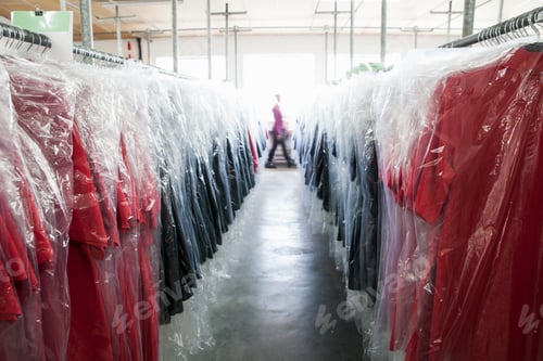 Preview: Diminishing perspective of garments on clothes rail in sewing factory