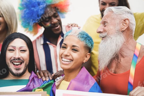 Preview: Multiracial gay people having fun at pride parade with LGBT flags and banners