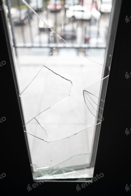 Preview: Broken window pane after vandalism. Door after a burglary.