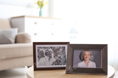 Preview: Portraits in stylish frames on table indoors