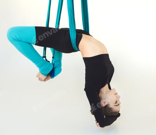 Preview: Young Slim Woman Practicing Fly Yoga Asana Over White Background In Fitness Gym, Crop. Health