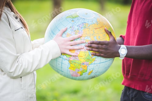 Preview: Multiracial Teen Couple Holding Globe Map