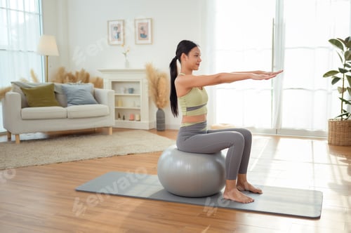 Preview: Young asian woman exercising with fitness ball