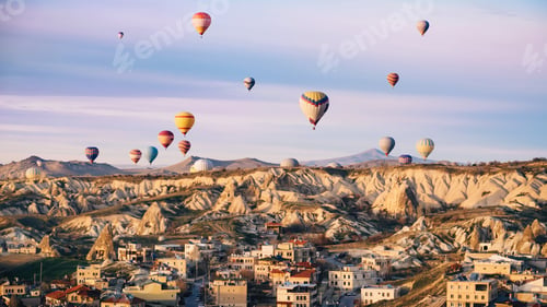 Preview: Colorful hot air balloons flying over the city at Cappadocia, Turkey. Volcanic mountains in Goreme n