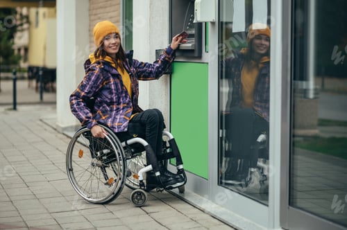 Preview: Woman with disability using credit card and atm machine