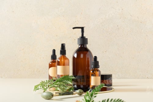 Preview: Amber glass bottles on beige background