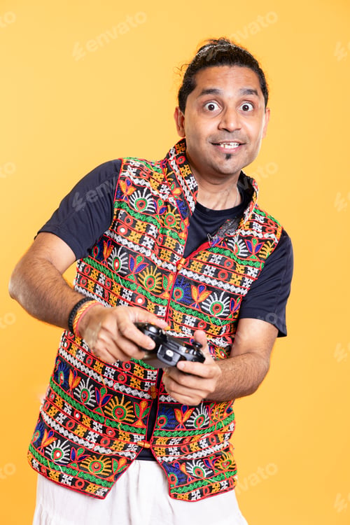 Preview: Portrait of joyous man being entertained by videogames, using controller