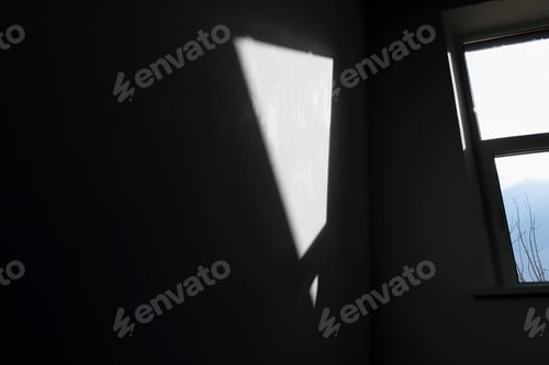 Preview: Abstract background with window reflection on dark gray concrete wall.