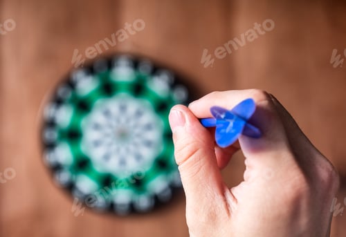 Preview: Hand throwing dart arrow to dartboard