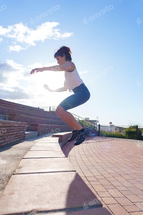 Preview: Female athlete jumping in a park, demonstrating athleticism and engaging in urban training