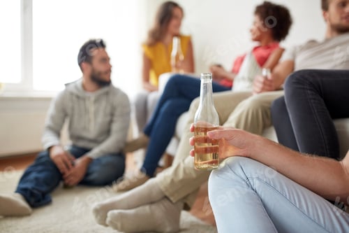 Preview: close up of man with beer bottle and friends