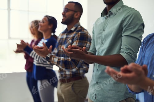 Preview: That was outstanding. Cropped shot of a team of designers applauding together in an office.