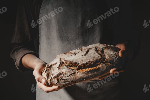 Preview: Baker or chef holding fresh made bread