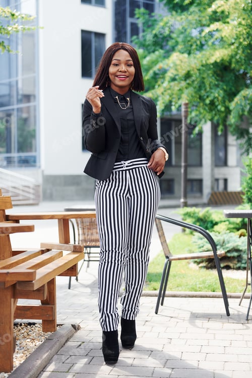 Preview: Young afro american woman in fashionable clothes outdoors in the city