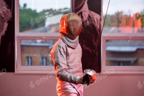 Preview: A guy in a fencing suit with a sword in his hand, neon light. A young model trains and trains