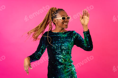 Preview: Black ethnic woman with braids party dancing on pink background, having fun ballerina