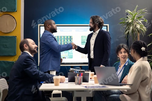 Preview: Business partners celebrate the starting point of a project between their firms