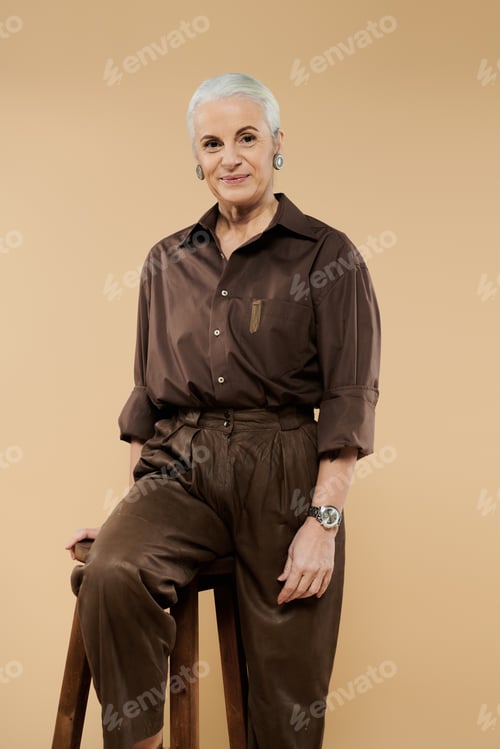 Preview: Captivating Portrait of a Mature Woman With Her Adult Daughter in a Warm Studio Setting