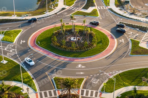 Preview: Roundabout intersection on American road with driving cars.