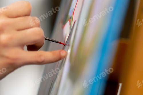 Preview: an art studio a painting with flowers the artist sitting the details on the painting with red paint