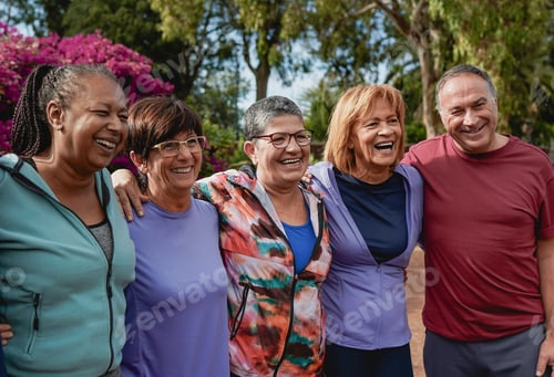 Preview: Group of fit senior people having fun hugging each other after sport workout at city park
