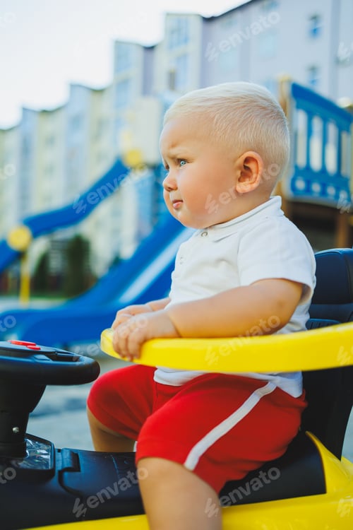 Preview: A little boy rides a tolocar. Tolokar for babies. Children's car for skating.