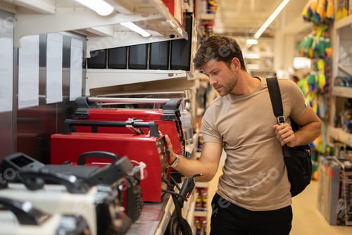 Preview: Male in store with electric instruments