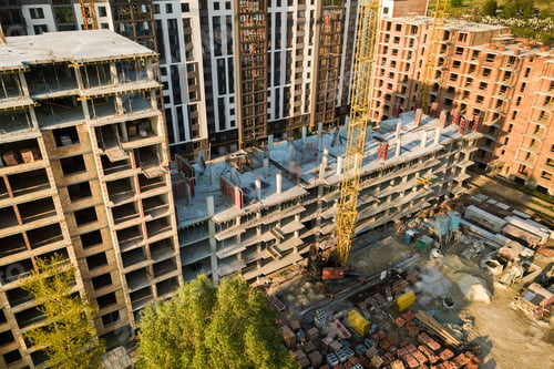 Preview: High multi storey residential apartment buildings under construction. Concrete and brick framing of