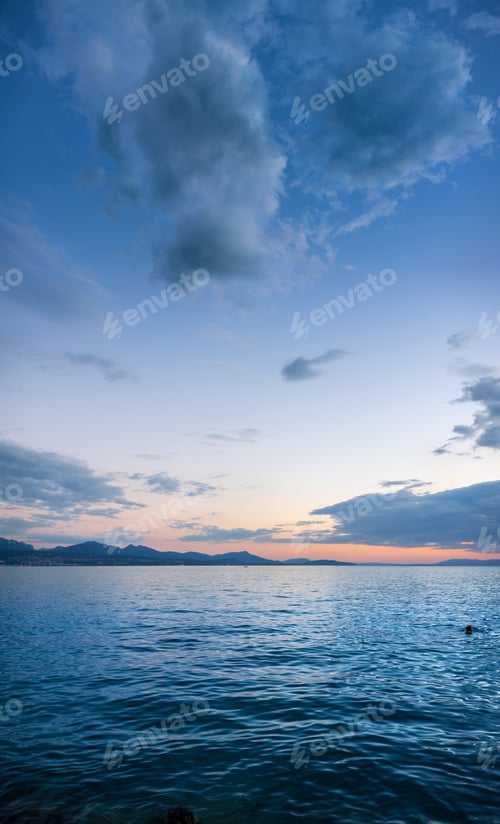 Preview: Vertical shot of a beautiful sea under a blue cloudy sky