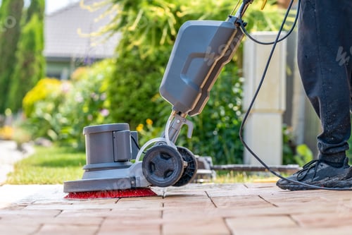 Preview: worker manually cleaning pavements with a mechanical brush