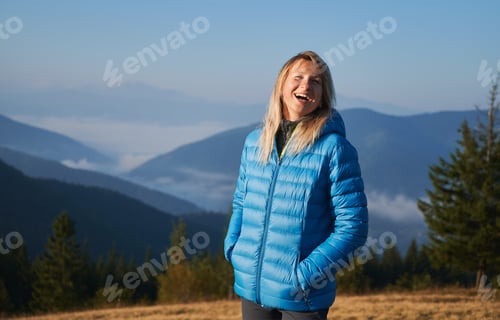 Preview: Alone blonde girl walking in the mountains.