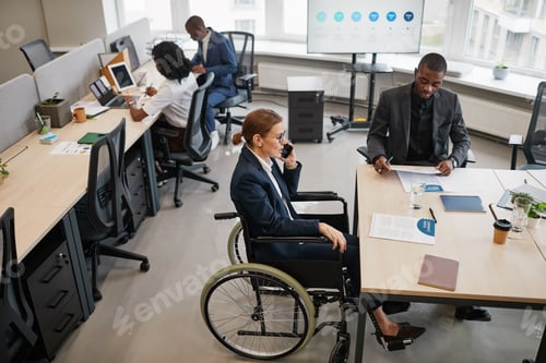 Preview: Female Manager using Wheelchair in Office