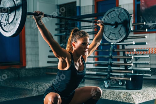 Preview: Cross training. Female athlete lifting heavy barbells