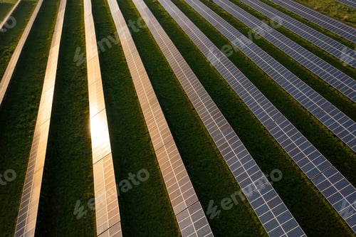 Preview: Sunlight reflecting on solar panels on farmland