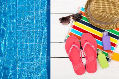 Preview: Summer relaxation by the pool with colorful accessories, flip flops, and refreshing drinks