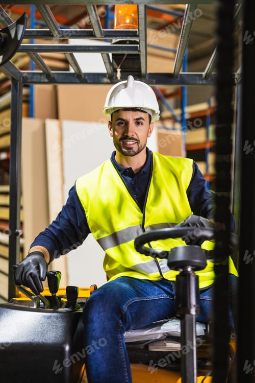 Preview: Worker operating forklift in industrial lumberyard warehouse