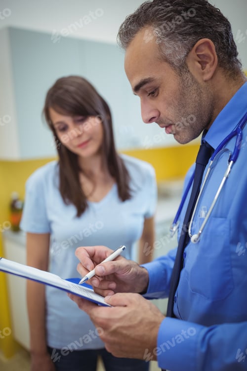 Preview: Doctor interacting with patient and writing on clipboard