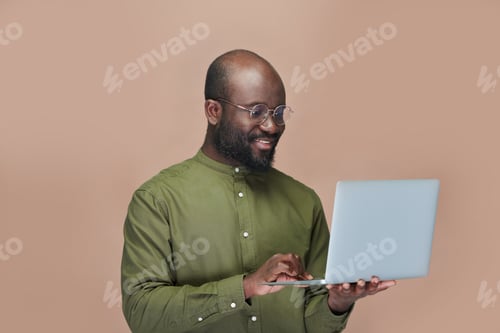 Preview: African American man using laptop computer