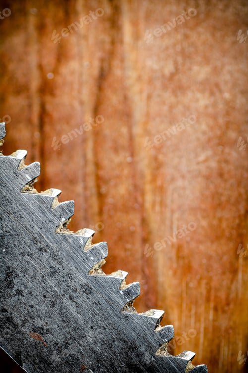 Preview: Hand saw blade on a wooden background.