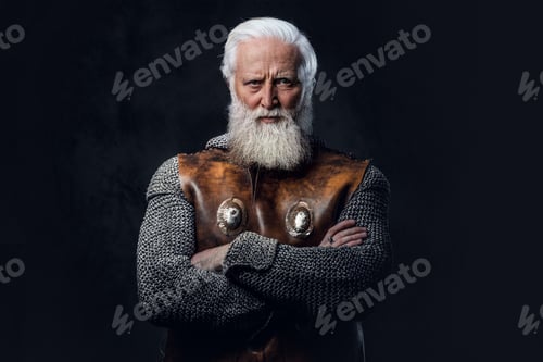 Preview: Confident elderly knight with crossed arms against dark background