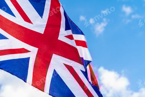 Preview: United Kingdom Flag waving on wind in blue sky