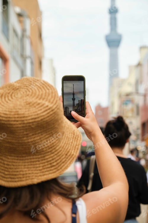 Preview: Tourist woman taking a photo with the smartphone at the Tokyo Skytree.
