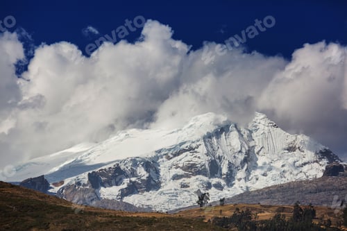 Snow Capped Mountain Peaks with Clouds and Sky