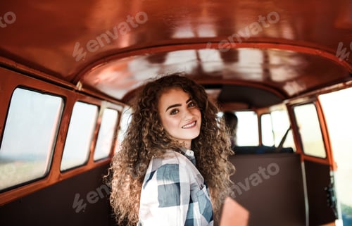 Preview: A young girl in a car on a roadtrip through countryside.