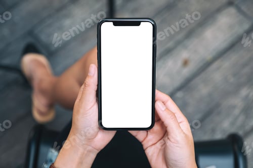 Preview: A woman holding a black mobile phone with blank white desktop screen