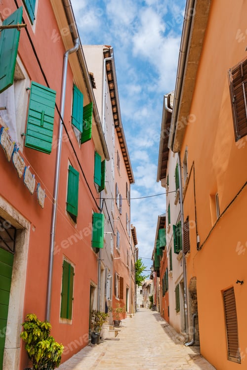 Preview: Charming narrow alley in Rovinj, Croatia, showcasing colorful buildings on a sunny day
