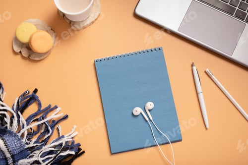Preview: Office table desk with set of colorful supplies, blank blue paper note pad, plaid, cup, pen