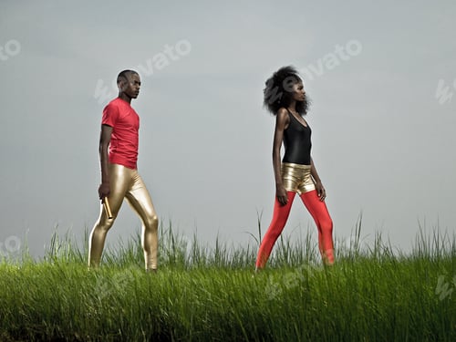 Stylish Man and Woman Posing in Field